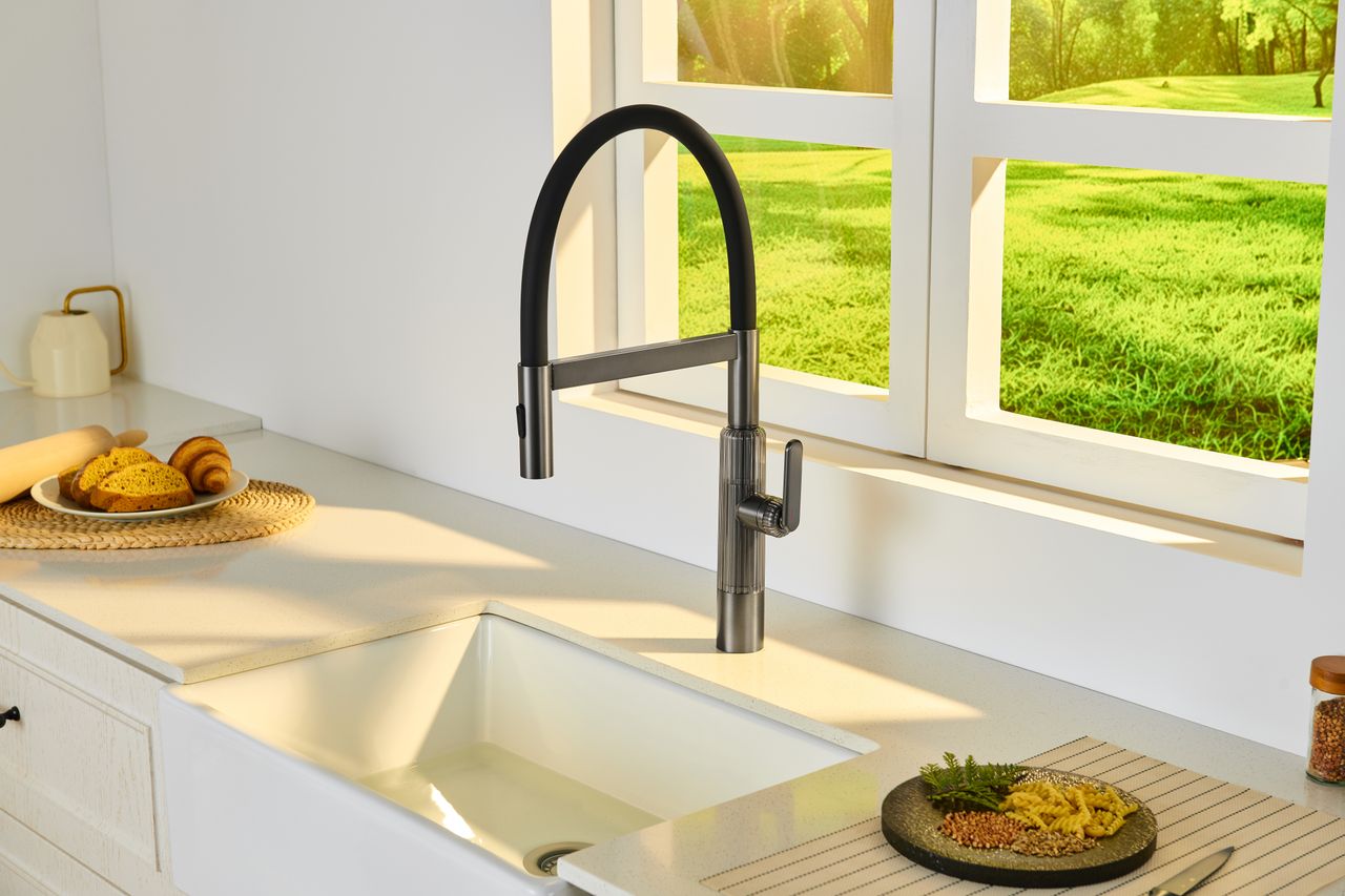 Bright kitchen interior featuring a sleek faucet, sink, and a scenic window view.
